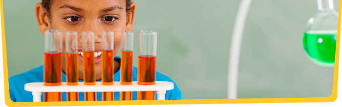 Boy looking at test tubes