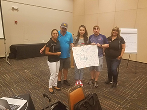 Jazmin Pando, Steven Goluska and other Pecos Valley REC 8 members pose together